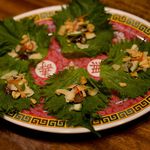 Perilla leaf with toasted shrimp, coconut, tamarind caramel and peanuts(Sam Horine/ Gothamist) 